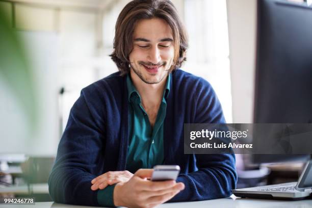 young handsome businessman using smart phone - technophiler mensch stock-fotos und bilder