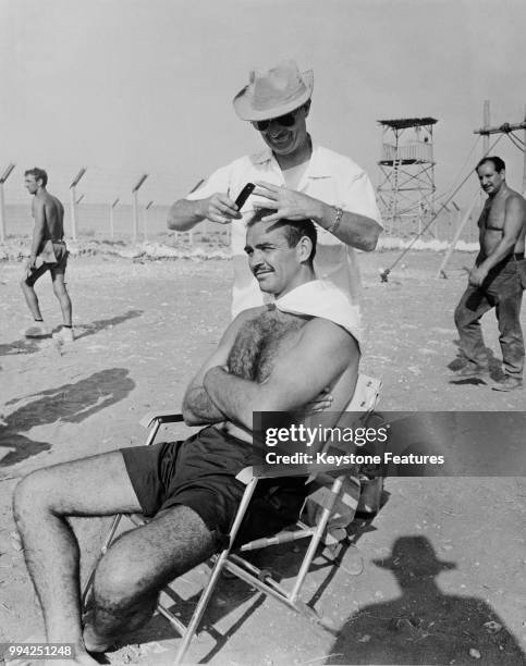 Scottish actor Sean Connery has his hair shaved off on the set of the film 'The Hill', 1965.