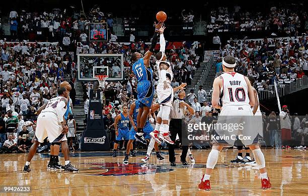 Dwight Howard of the Orlando Magic jumps for the opening tipoff against Josh Smith of the Atlanta Hawks during Game Three of the Eastern Conference...