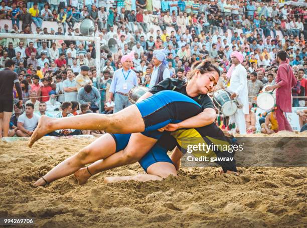 women wrestlers fight kushti at shoolini fair in solan, himachal pradesh. - gawrav stock pictures, royalty-free photos & images