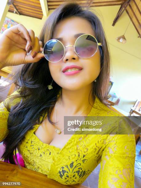 young asian girl taking selfie - bali women tradition head stock pictures, royalty-free photos & images