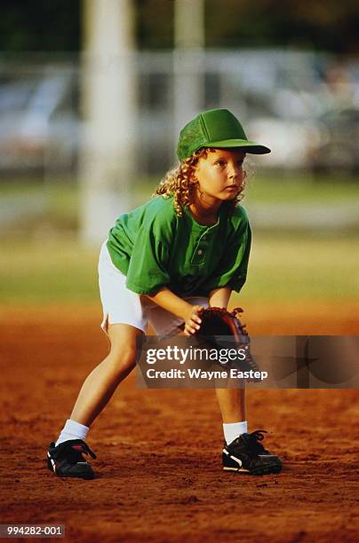 girl (8-10) playing in baseball game,wearing hat and baseball glove - girl baseball cap stock pictures, royalty-free photos & images