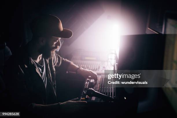 radio station dj working on sound mixer and broadcasting music - waveform monitor stock pictures, royalty-free photos & images