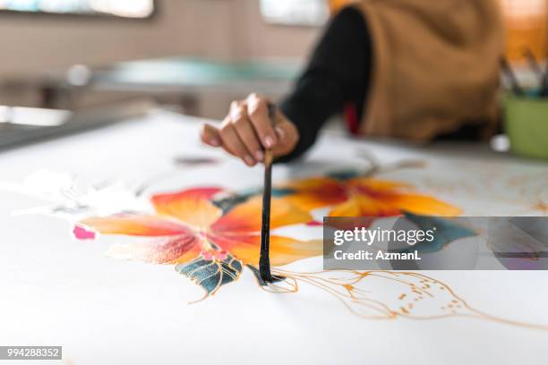 woman painting in a batik workshop - batik painting stock pictures, royalty-free photos & images