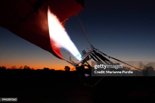 the burner adding hot air to the envelope - fun northern territory stock pictures, royalty-free photos & images