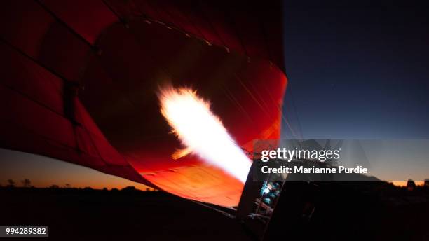 the burner adding hot air to the envelope - fun northern territory stock pictures, royalty-free photos & images