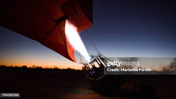 the burner adding hot air to the envelope - fun northern territory stock pictures, royalty-free photos & images