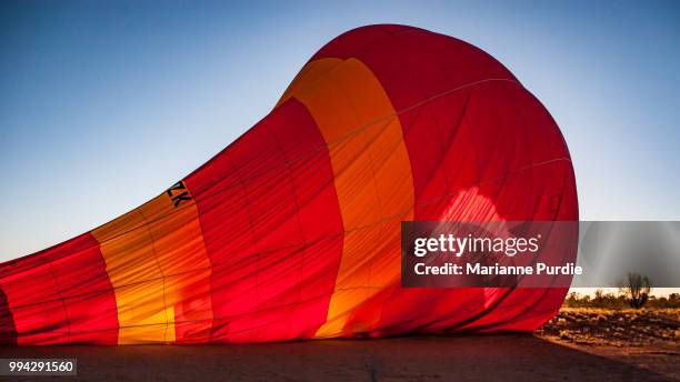 hot air balloon deflating after a flight - fun northern territory stock pictures, royalty-free photos & images