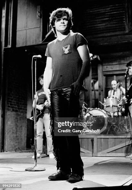 American Rock, County, and Folk musician John Cougar performs, with his hand the Zone, during a dress rehearsal for the television show 'Saturday...