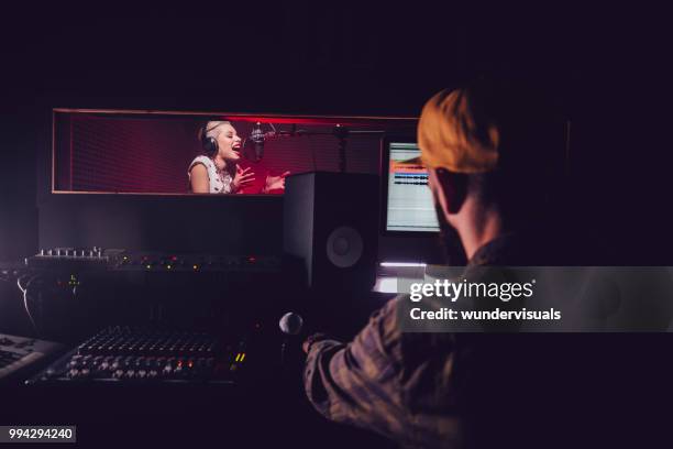 hipster pop music artist recording song at professional music studio - music producer stock pictures, royalty-free photos & images