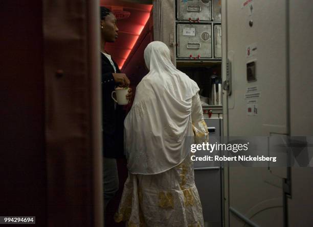 Passengers gather in the galley of an Airbus 380 Emirates Airlines flight June 30, 2018 from Dubai to JFK International Airport in New York.