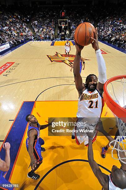 Ronny Turiaf of the Golden State Warriors dunks against Toney Douglas of the New York Knicks during the game at Oracle Arena on April 2, 2010 in...