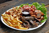 Snacks with fries, crackers, meat, pork, sausage and babercue sauce