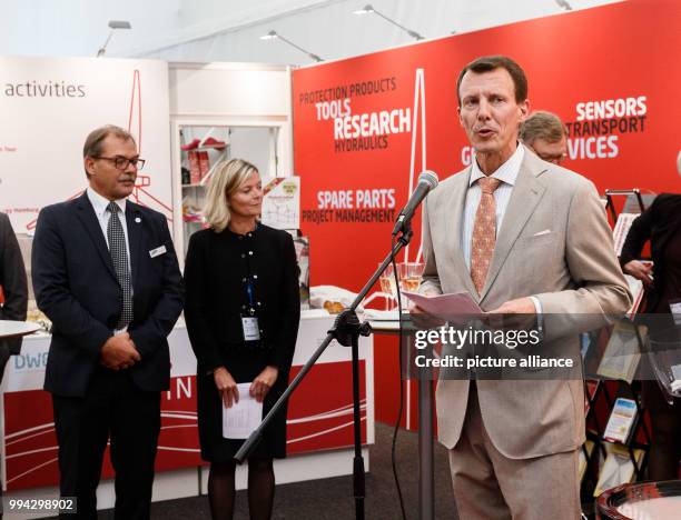 Prince Joachim of Denmark delivers remarks next to Danish Consuls General Martine Gram Barbry and Henrik Becker Christensen at the joint booth of the...