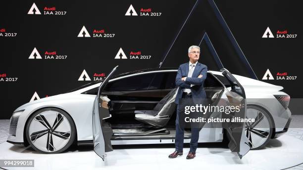 Dpatop - Audi chairman Rupert Stadler stands next to the Audi concept car Aicon at the International Motor Show in Frankfurt, Germany, 14 September...