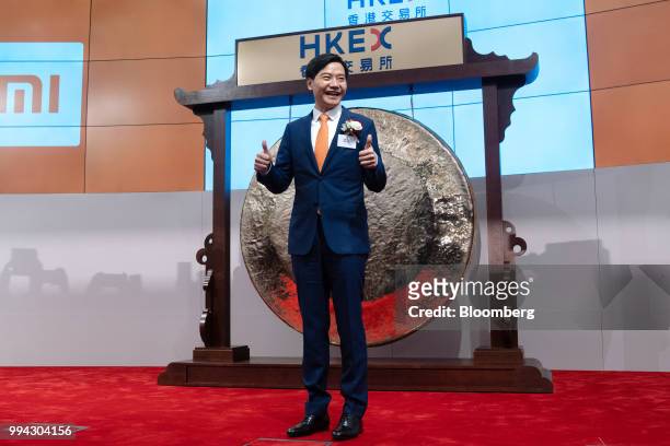 Lei Jun, chairman and chief executive officer of Xiaomi Corp., gives a thumbs up while posing for photographs during the company's listing ceremony...