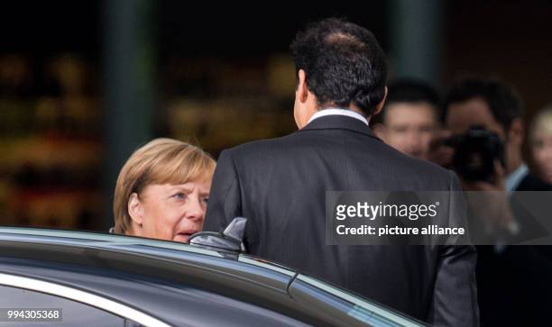 German Chancellor Angela Merkel greets the Emir of Qatar, Sheikh Hamad bin Khalifa Al Thani, outside the federal chancellery in Berlin, Germany, 15...