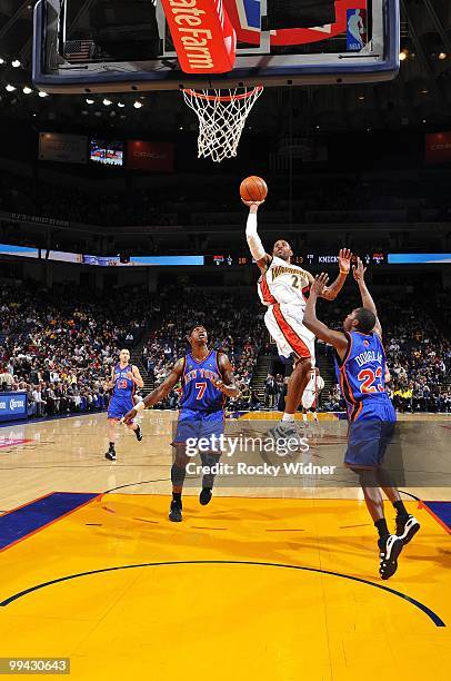 Watson of the Golden State Warriors goes up for a shot against Toney Douglas and Al Harrington of the New York Knicks during the game at Oracle Arena...