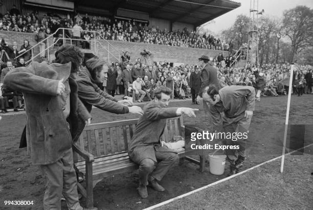 English former footballer and manager of Brighton & Hove Albion, Brian Clough points from a bench as he instructs his players during the FA Cup match...