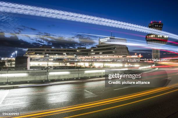 Blue sky in the evening behind the tower and main terminal of Tegel Airport in Berlin, Germany, 14 September 2017. In the foreground the lights of...