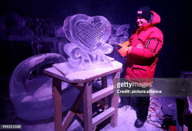 Ice carving world champion Sergey Tselebrovskiy from Russia improving his exhibition "Moby Dick" at the ice world in Karls Erlebnis-Dorf in...