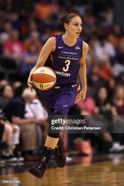 Diana Taurasi of the Phoenix Mercury handles the ball during the first half of WNBA game against the Connecticut Sun at Talking Stick Resort Arena on...