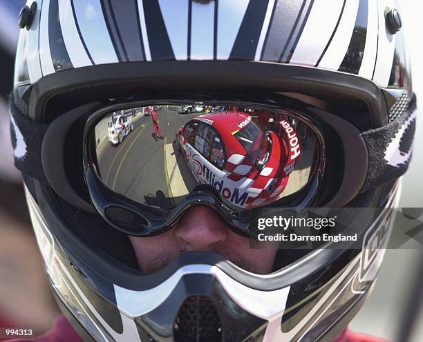 The Holden Racing Team car of Mark Skaife and Jason Bright is reflected in the visor of Holden Racing Team mechanic during qualifying for the V8...