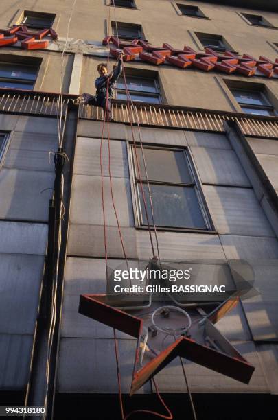 Des employés retirent une étoile rouge du fronton d'un immeuble à Prague en décembre 1989, République Tchèque.