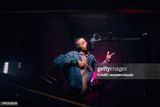 young hipster african-american rapper recording songs in music recording studio - musica imagens e fotografias de stock
