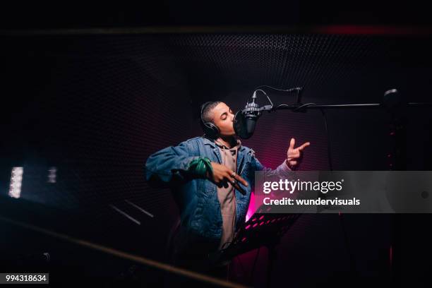 young hipster african-american rapper recording songs in music recording studio - pop music imagens e fotografias de stock