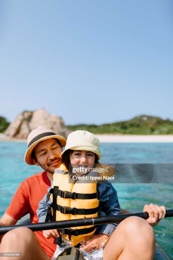 Father and daughter sea kayaking together, Okinawa, Japan
