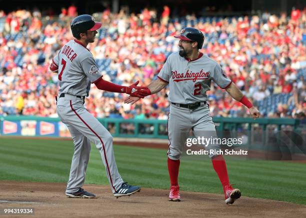 Trea Turner of the Washington Nationals is congratulated by Adam Eaton after hitting a two-run home run during the first inning of a game against the...