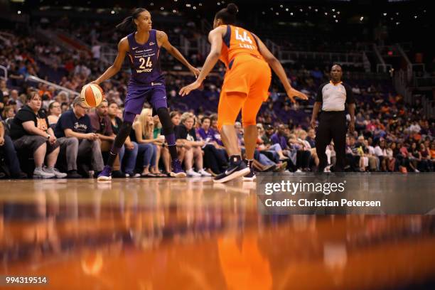 DeWanna Bonner of the Phoenix Mercury handles the ball against Betnijah Laney of the Connecticut Sun during the first half of WNBA game at Talking...