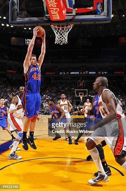 David Lee of the New York Knicks rebounds against Anthony Tolliver of the Golden State Warriors during the game at Oracle Arena on April 2, 2010 in...