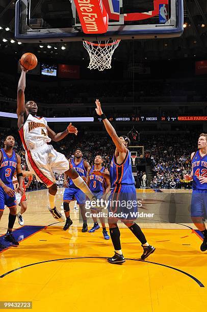 Anthony Tolliver of the Golden State Warriors shoots a layup against J.R. Giddens of the New York Knicks during the game at Oracle Arena on April 2,...