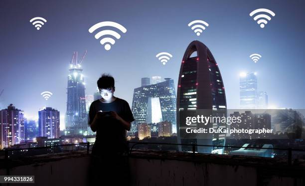 man using a mobile phone in beijing cbd - dukai stockfoto's en -beelden