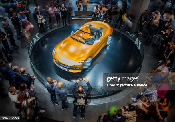 Man takes a picture of a BMW Z4 in Frankfurt am Main, Germany, 16 September 2017. The International Motor Show Germany takes place from 14-24...
