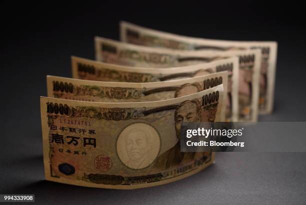 Japanese 10,000 yen banknotes are arranged for a photograph in Kawasaki, Kanagawa Prefecture, Japan, on Saturday, July 7, 2018. Japans currency rose...