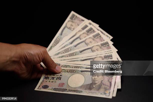 Japanese 10,000 yen banknotes are arranged for a photograph in Kawasaki, Kanagawa Prefecture, Japan, on Saturday, July 7, 2018. Japans currency rose...