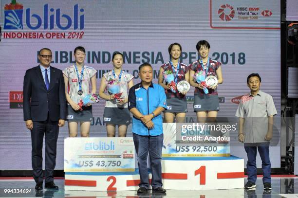 Yuki Fukushima and Sayaka Hirota o from Japan are seen on podium after becaming women's doubles champion at the Indonesia Open tournament after...