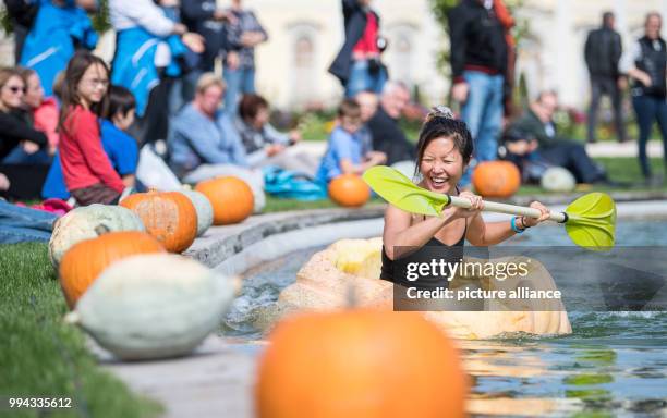 Gina Lee paddles in a pumpkin boat during the first day of the pumpkin boat race in the gardens of the Bluehende Barock in Ludwigsburg, Germany, 16...