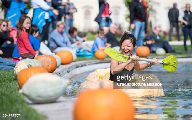 Gina Lee paddles in a pumpkin boat during the first day of the pumpkin boat race in the gardens of the Bluehende Barock in Ludwigsburg, Germany, 16...