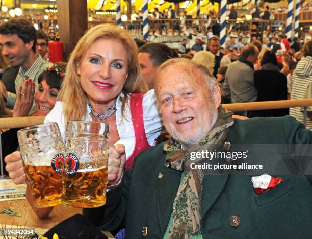 Direcotr Joseph Vilsmaier and his partner Birgit Muth celebrate in the Winzerer Faehndl on the opening day of the Oktoberfest fun fair in Munich,...