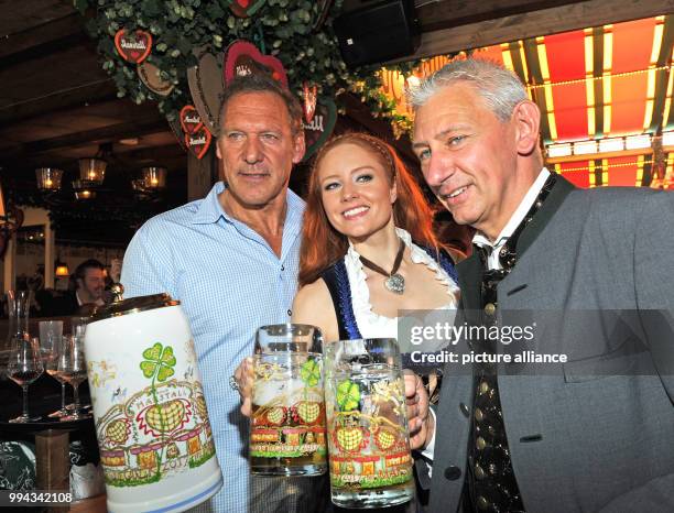 Actor Ralf Moeller , model Barbara Meier and beer tent proprietor Siegfried Able celebrate in the Marstall festival tent on the opening day of the...