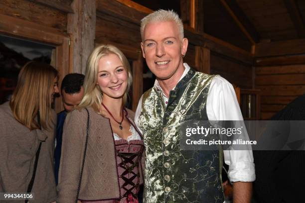 Musician H.P. Baxxter and his girldfriend Lysann Geller seen on the balcony of the Kaefer festival tent on the opening day of the Oktoberfest funfair...