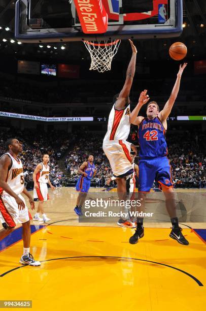 David Lee of the New York Knicks shoots a layup against Ronny Turiaf of the Golden State Warriors during the game at Oracle Arena on April 2, 2010 in...
