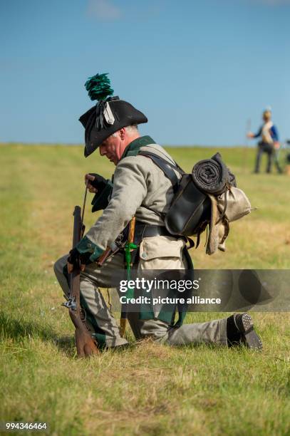 Dpatop - An actor, dressed as a 19th century soldier, loads his weapon, during a reenactment of the Battle of the Gohrde, near Lueben, Germany, 17...