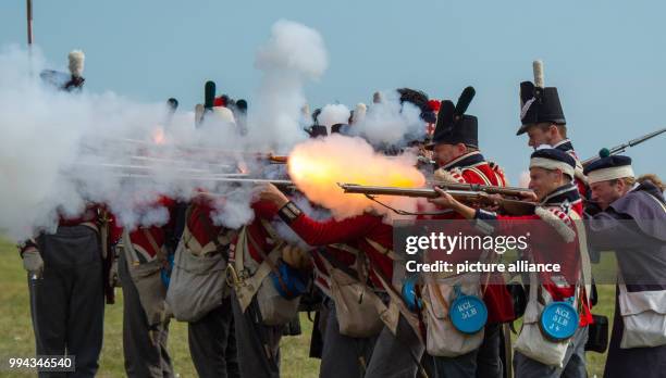 Dpatop - Actors, dressed as 19th century soldiers, fire their weapons during a reenactment of the Battle of the Gohrde, near Lueben, Germany, 17...