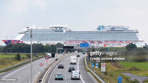 The latest cruise ship "World Dream", built by the Meyer Werft shipyard in Papenburg, is being braught to the North Sea along the river Ems and is...