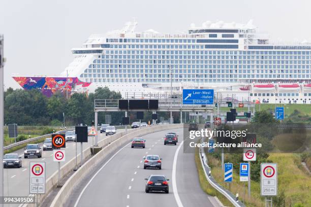 The latest cruise ship "World Dream", built by the Meyer Werft shipyard in Papenburg, is being braught to the North Sea along the river Ems and is...